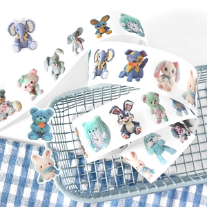 Cute animal illustration washi tape roll featuring elephants and rabbits on a blue wire basket