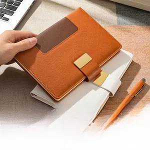 Close-up of A5 soft leather notebook with orange cover and metallic magnetic buckle
