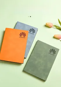 Detail of soft leather A5 notebooks in orange, grey, and green with custom logo embossing