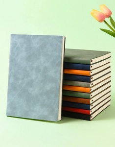 Detailed stack of colorful A5 leather notebooks with premium matte texture and thick pages