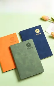 Detail of custom PU leather business notebooks in orange, navy and green colors