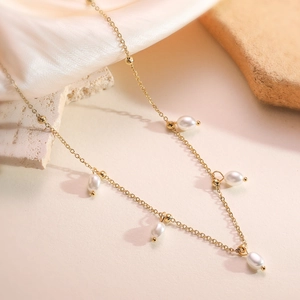 French vintage 18K gold plated pearl necklace with five oval beads on satin background