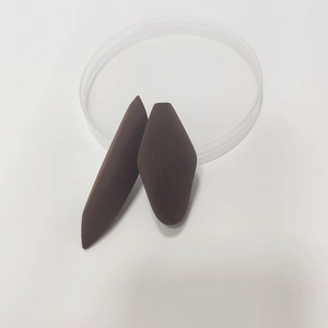 Detailed macro view of two brown matte diamond-shaped beauty sponges for makeup blending