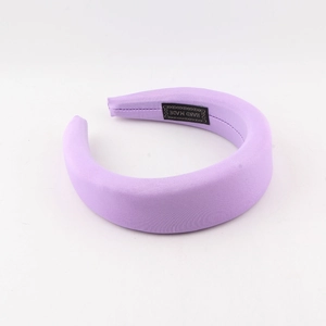 Close-up of lavender padded headband with soft satin finish and handmade inner label