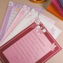 Detailed view of fan-shaped pearlescent tissue paper with floral and butterfly patterns