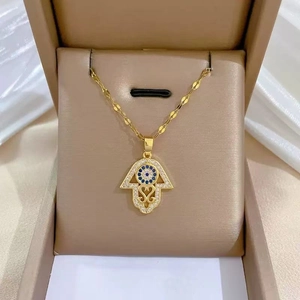 Luxury gold-plated Hamsa Hand necklace with blue Evil Eye and pavé crystals in a box