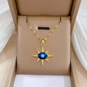 Close-up of luxury evil eye starburst pendant necklace in a light brown jewelry box