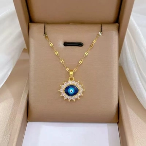 Detailed view of luxury gold-plated evil eye pendant with sparkling crystal halo inlay