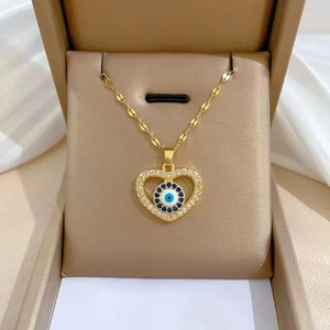 Macro shot of gold-plated evil eye heart necklace with zirconia pavé in a gift box