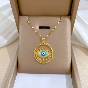 Close-up of gold plated evil eye necklace with sparkling rhinestones in a gift box