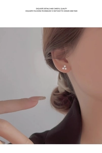 Close-up of elegant small flower pearl earrings featuring three white micro pearls on ear