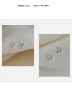 Macro detail of three elegant white pearls arranged in a delicate triangle stud earring