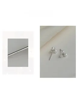 Macro shot of S925 hallmark on silver earring post with three small white pearls