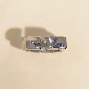 Detailed view of silver irregular lava texture adjustable ring with reflective finish