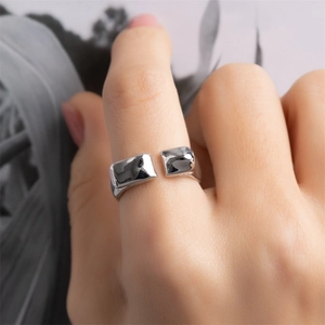 Macro shot of silver molten lava texture open ring with irregular rectangular details