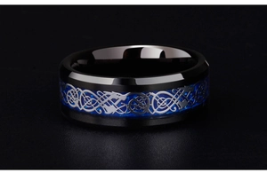 Close-up of black tungsten ring with blue carbon fiber inlay and silver Celtic dragon pattern