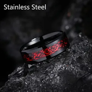 Men's black stainless steel ring featuring red Celtic dragon inlay on dark rock base
