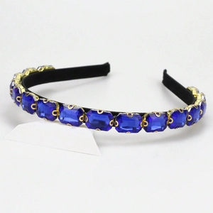 Elegant headband featuring rectangular royal blue crystals set in golden metal prongs