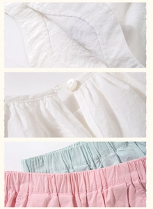 Detail of girl's summer outfit showing buttoned neckline and elastic waist stitching