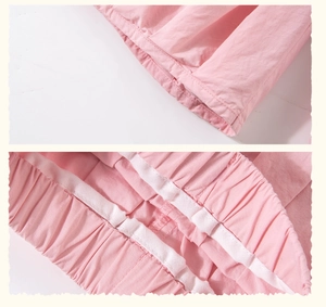 Close-up of pink cotton fabric stitching and elastic waistband on girls clothing set