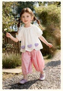 Girl's summer set featuring white puff-sleeve top with purple hearts and pink trousers