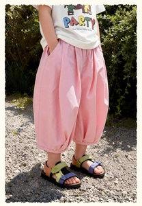 Detail view of pink loose-fit cotton trousers with elastic waist for young girls