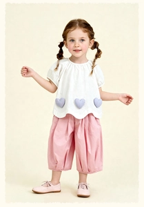Detail of girls summer set with white heart print blouse and pink cropped lantern pants