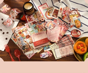 Detailed close-up of retro Food Diary stickers and vintage paper on a rustic wooden desk