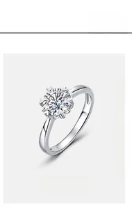 Macro shot of 1 carat round cut moissanite set in a six-prong silver mounting detail