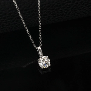 Macro shot of a brilliant round cut one carat diamond pendant with a four-prong setting