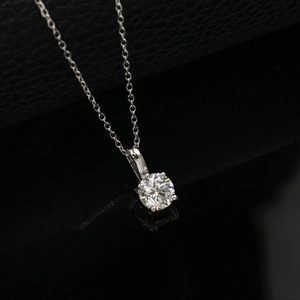 Detailed macro view of a round brilliant-cut lab diamond in a classic four-prong silver setting