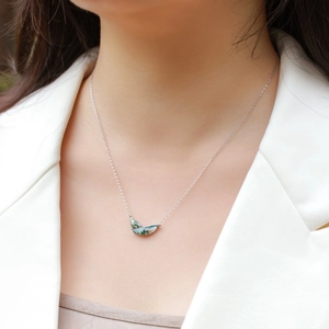 S925 silver crescent necklace featuring a natural green moss agate pendant on a model