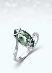 Macro detail of S925 silver moss agate ring with dragonfly and leaf design