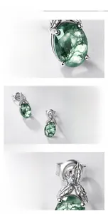 Detail view of leaf-shaped S925 silver earrings with natural green moss agate and crystals