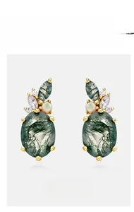 Detail of vintage gold-plated drop earrings with oval green moss agate and opal stones