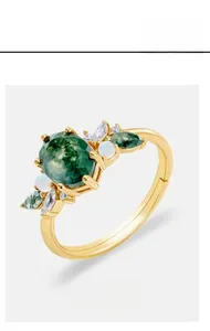 Detail view of moss agate gold ring with leaf prongs and marquise side stones