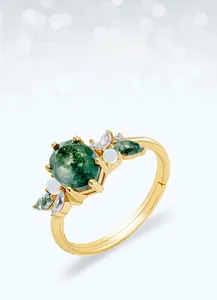 Detailed close-up of moss agate ring with opal and diamonds on a gold-plated silver band