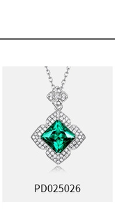 Macro shot of silver emerald-cut green gemstone necklace with pavé set diamond halo