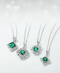 Detail view of four sterling silver lab emerald pendants with micro-pave cubic zirconia