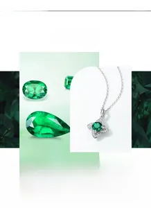 Macro shot of silver four-leaf petal pendant with round green emerald and white cubic zirconia