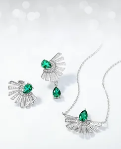Macro shot of S925 silver pear-cut emerald earrings and necklace with white zircon