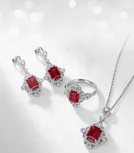 Macro detail of lab-grown ruby jewelry set with emerald-cut stones and silver plating