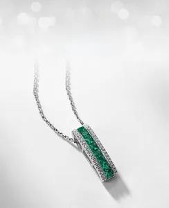Macro detail of lab-grown emerald pendant with S925 silver chain and pavé cubic zirconia