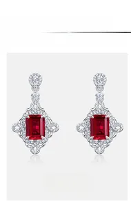 Detail of S925 silver earrings with ruby rectangle stones and small white diamonds