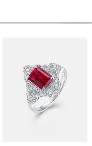 Macro shot of vintage S925 sterling silver ring with princess cut ruby and halo diamonds