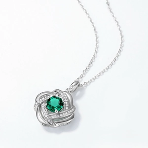 Luxurious S925 silver necklace with emerald gemstone and interlaced diamond halo