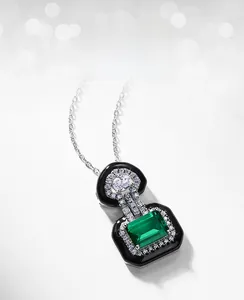 Close-up of lab-grown emerald necklace with square cut and sparkling zircon setting