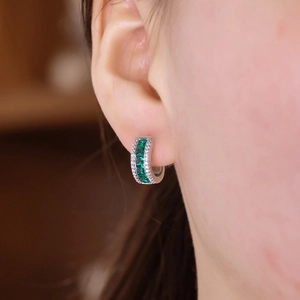 S925 sterling silver emerald hoop earrings with crystals shown on a model