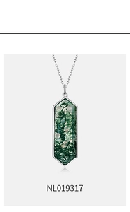 Detailed close-up of hexagonal moss agate pendant necklace in silver plated frame