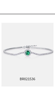 Close-up of S925 silver tennis bracelet with green emerald and round zircon inlay